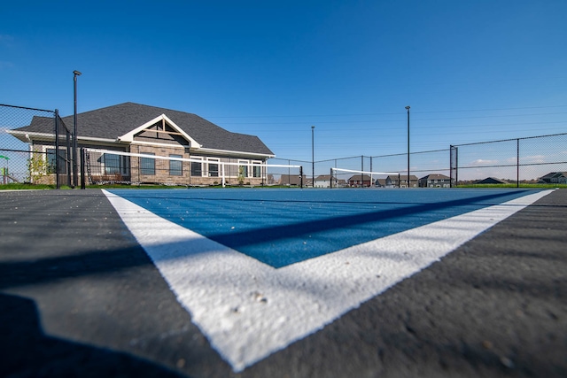 view of pool with tennis court