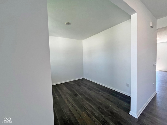 spare room with dark hardwood / wood-style floors