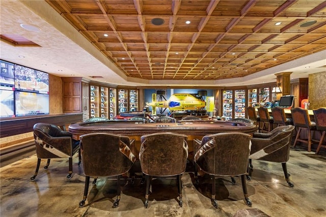 interior space with bar area, concrete flooring, and a tray ceiling