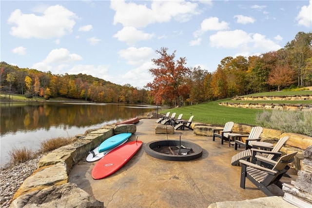 exterior space with a fire pit and a water view