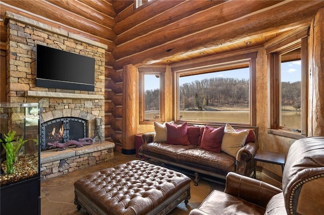 living room with a stone fireplace and log walls