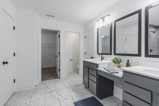 bathroom with vanity, tile floors, and toilet