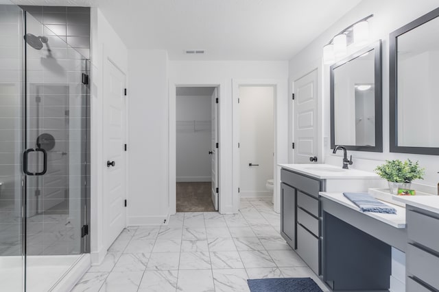 bathroom with an enclosed shower, vanity, toilet, and tile flooring