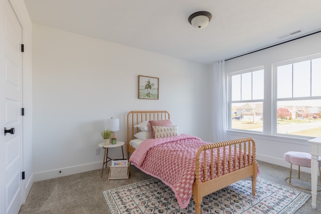 bedroom featuring light carpet