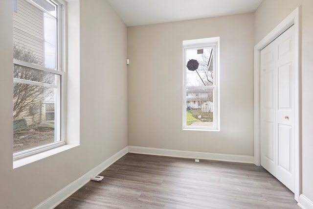 unfurnished bedroom with a closet and light wood-type flooring