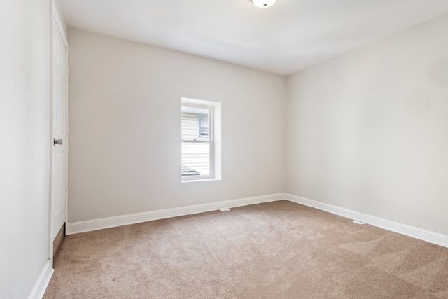 empty room featuring light carpet