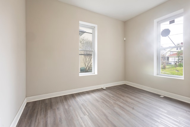 spare room with a healthy amount of sunlight and light wood-type flooring