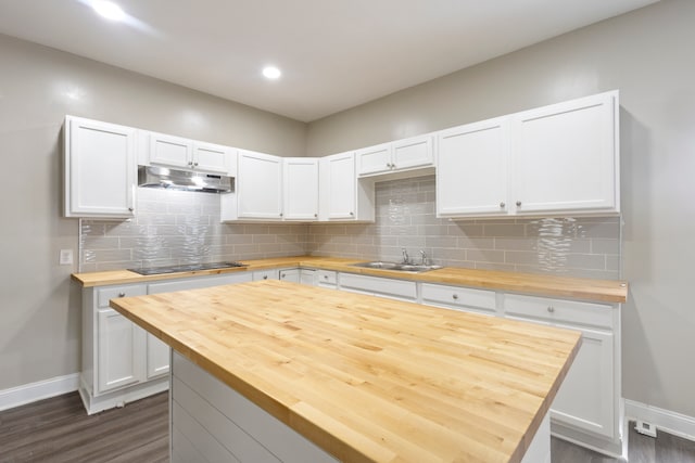 kitchen with tasteful backsplash, dark hardwood / wood-style flooring, wooden counters, and white cabinets