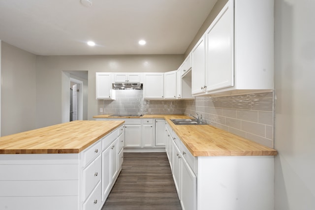 kitchen featuring butcher block countertops, tasteful backsplash, white cabinets, and dark wood-type flooring