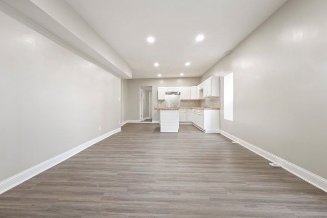 unfurnished living room featuring hardwood / wood-style flooring