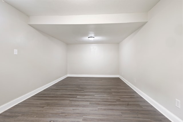 spare room with dark wood-type flooring