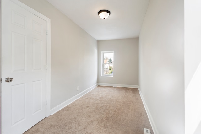 spare room with light colored carpet