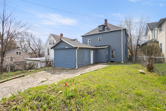 back of property featuring a lawn