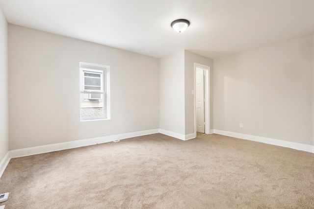 empty room featuring light carpet