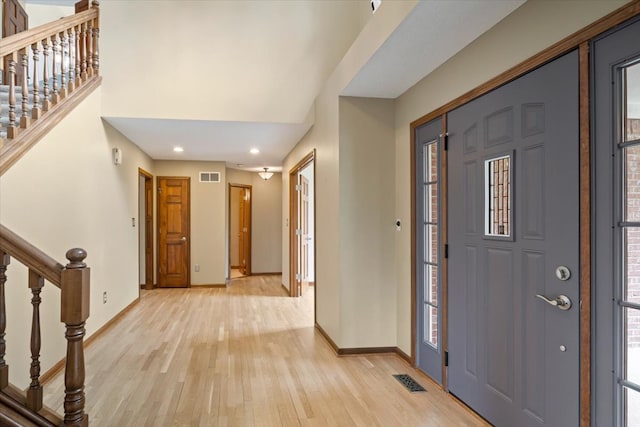 entrance foyer with light wood-type flooring and a healthy amount of sunlight