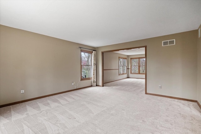 unfurnished room featuring light colored carpet