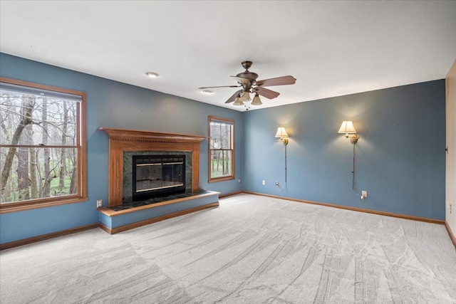 unfurnished living room with carpet floors and ceiling fan