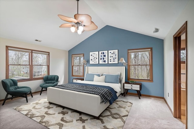 carpeted bedroom featuring multiple windows, ceiling fan, and vaulted ceiling