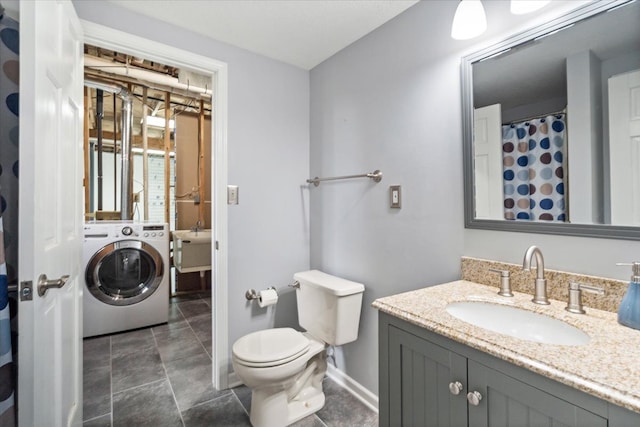 bathroom with tile patterned flooring, washer / dryer, toilet, and vanity