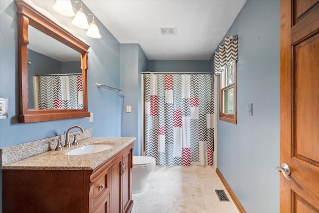 bathroom with vanity, tile patterned flooring, and toilet