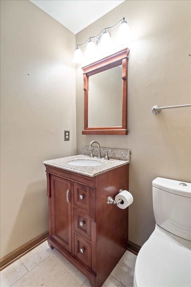 bathroom featuring vanity, toilet, and tile patterned floors