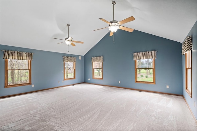 empty room with high vaulted ceiling, ceiling fan, and light colored carpet