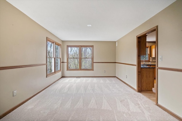 empty room featuring light carpet