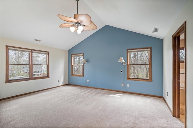 carpeted spare room featuring ceiling fan and lofted ceiling