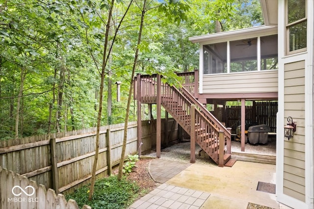 view of patio with a sunroom and a wooden deck