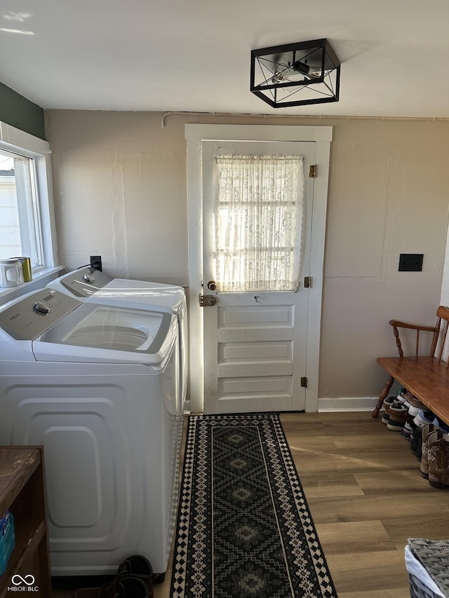 washroom with laundry area, wood finished floors, and washer and dryer