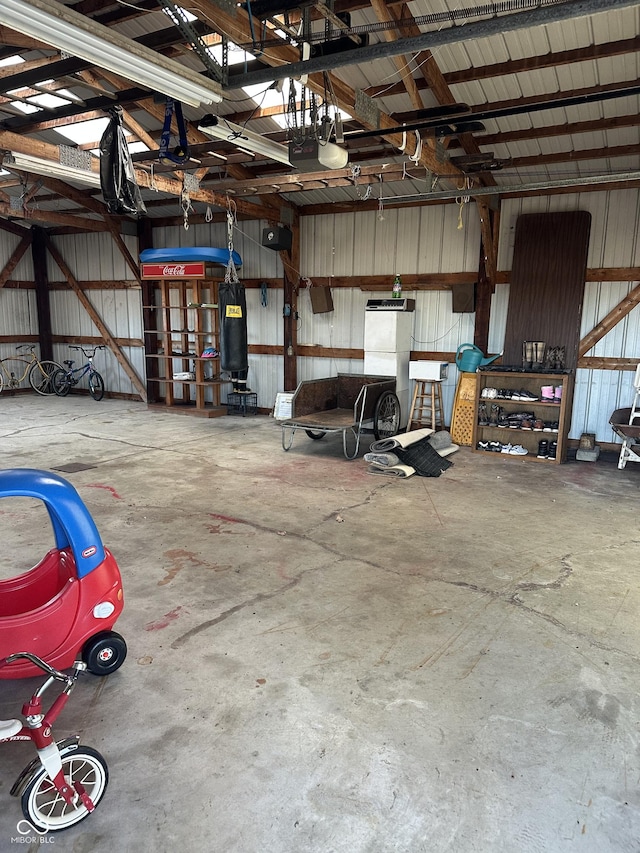 garage featuring a garage door opener and metal wall