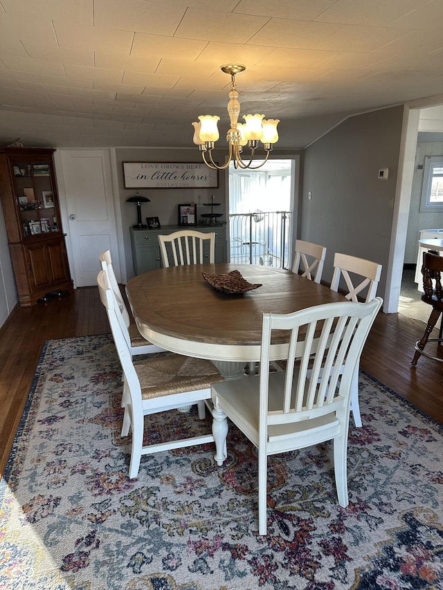 dining room with a chandelier, plenty of natural light, and dark wood finished floors