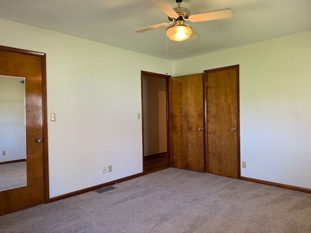 unfurnished bedroom with light carpet and ceiling fan