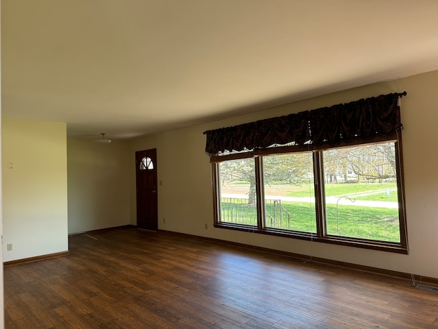 unfurnished room featuring dark hardwood / wood-style flooring