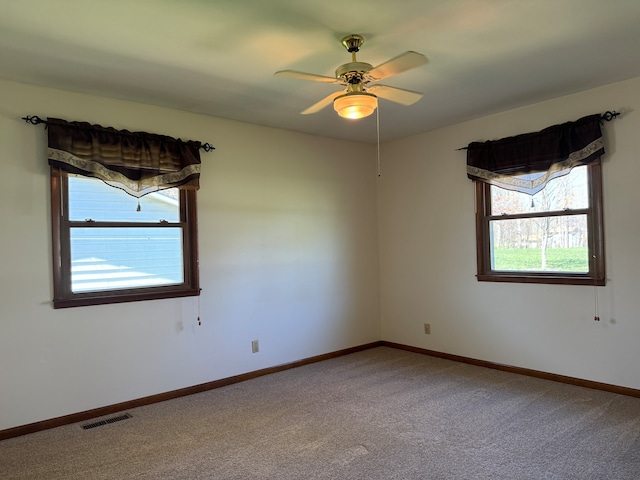 unfurnished room with ceiling fan and carpet flooring