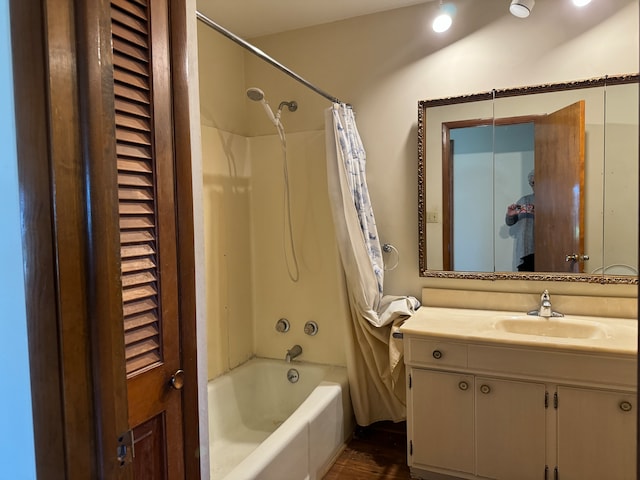 bathroom featuring shower / tub combo and vanity