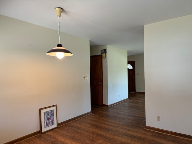 empty room featuring dark wood-type flooring