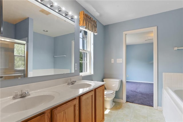 bathroom featuring large vanity, toilet, a bathtub, double sink, and tile floors