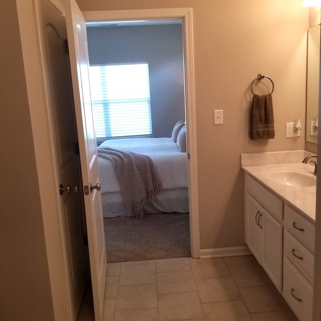 bathroom with vanity with extensive cabinet space and tile floors