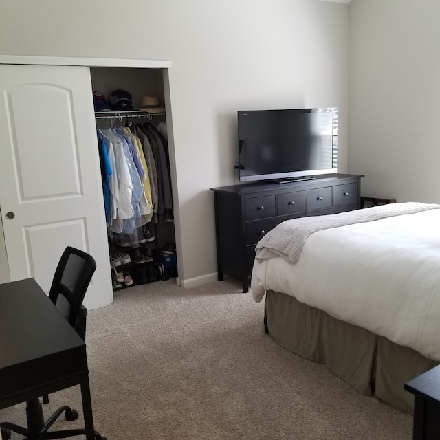 carpeted bedroom with a closet