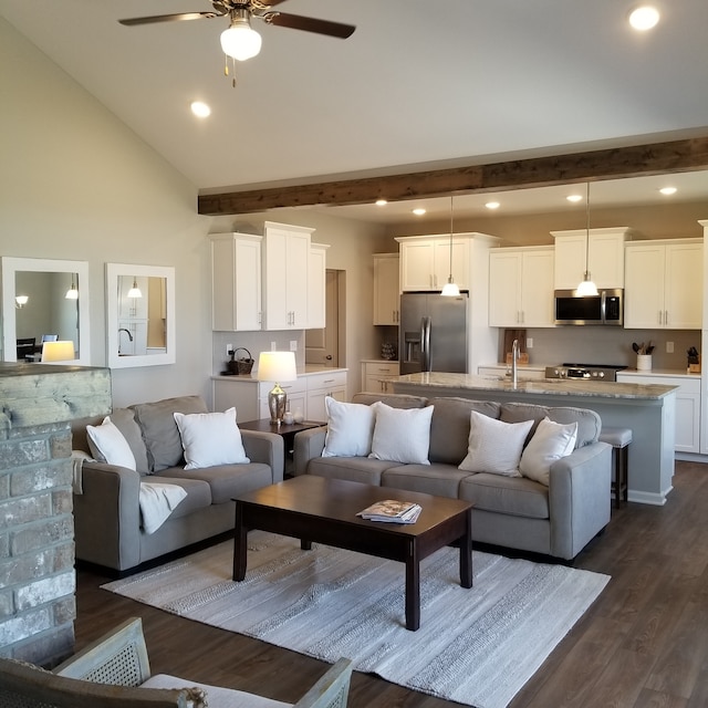 living room featuring high vaulted ceiling, dark hardwood / wood-style floors, beam ceiling, sink, and ceiling fan