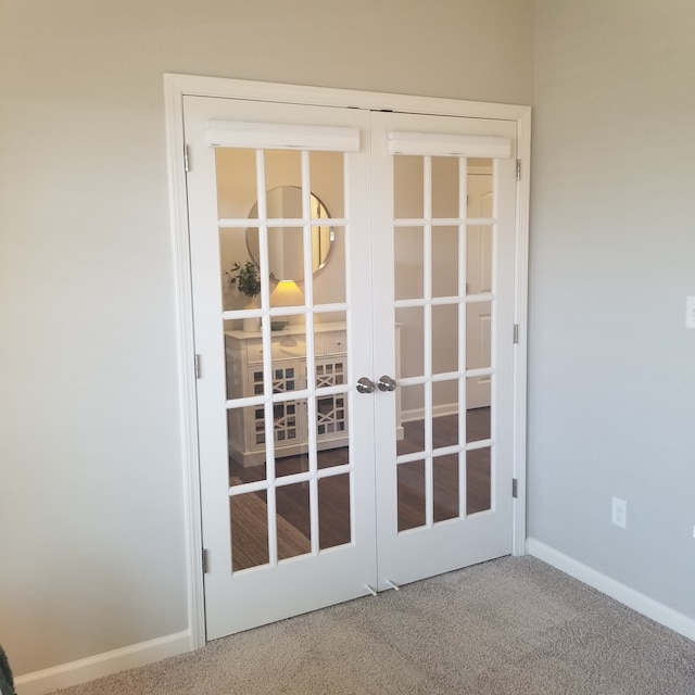 entryway with light colored carpet and french doors