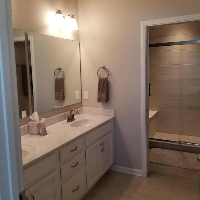 bathroom with double vanity and tile floors