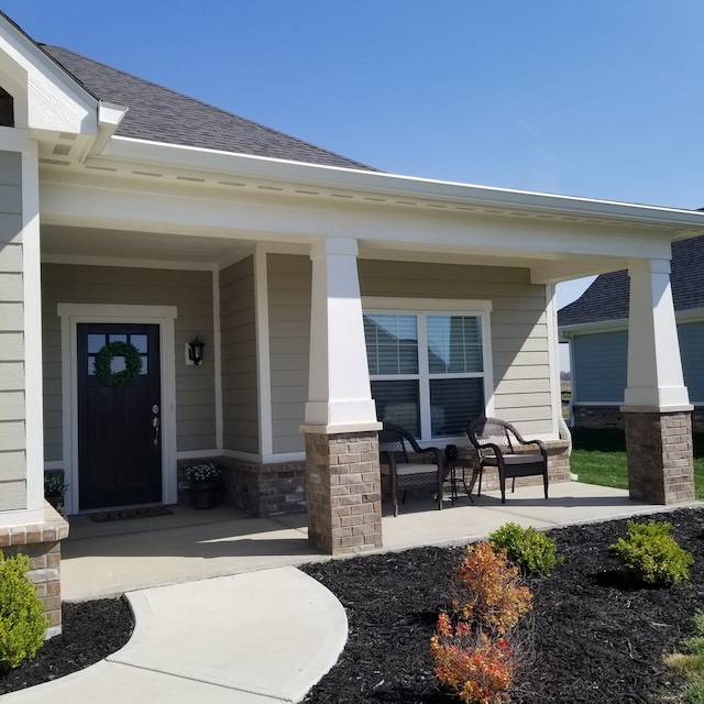 view of exterior entry with a porch