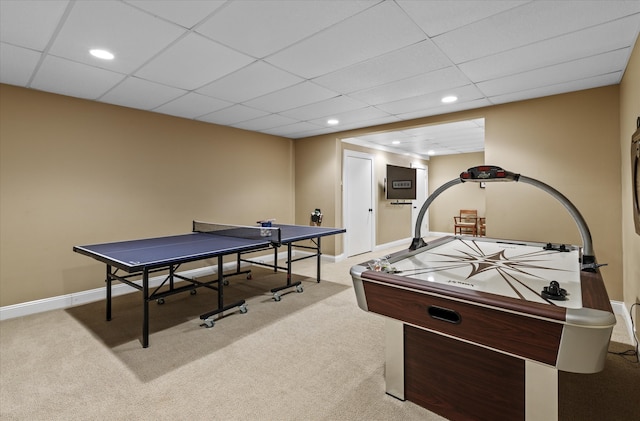 rec room with light colored carpet and a drop ceiling