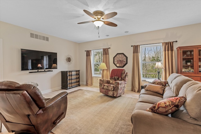 living room with light hardwood / wood-style floors and ceiling fan