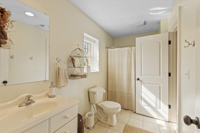 bathroom with toilet, tile floors, and vanity