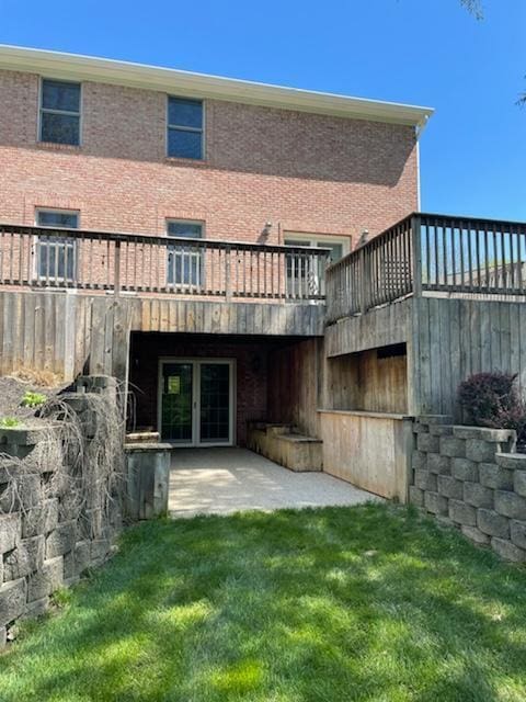 back of house featuring a lawn and a patio