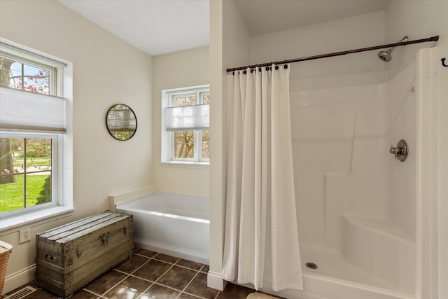 bathroom featuring tile floors and shower with separate bathtub