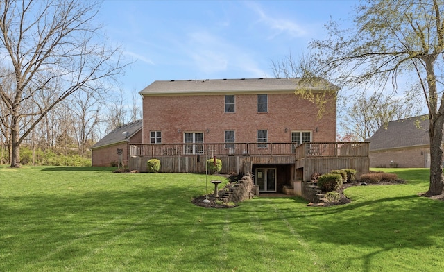 rear view of house featuring a deck and a yard